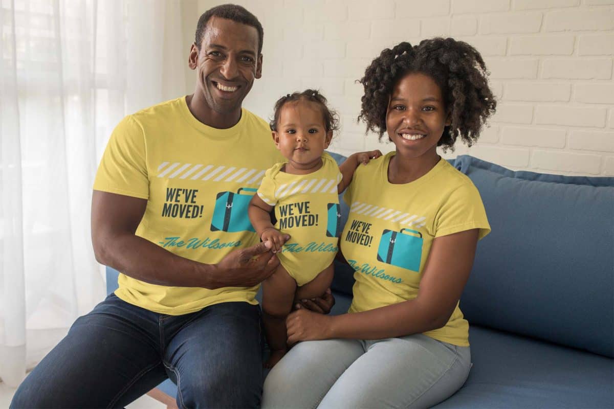 Smiling family wearing We've Moved t-shirts